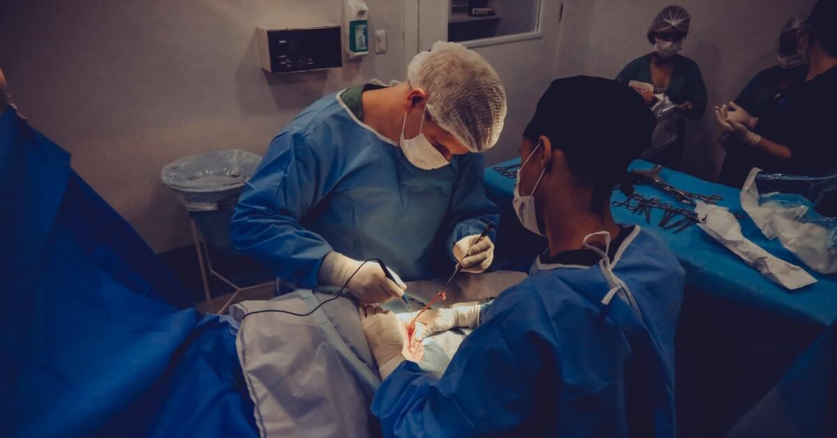 team of doctors and nurses performing laparoscopic hernia surgery